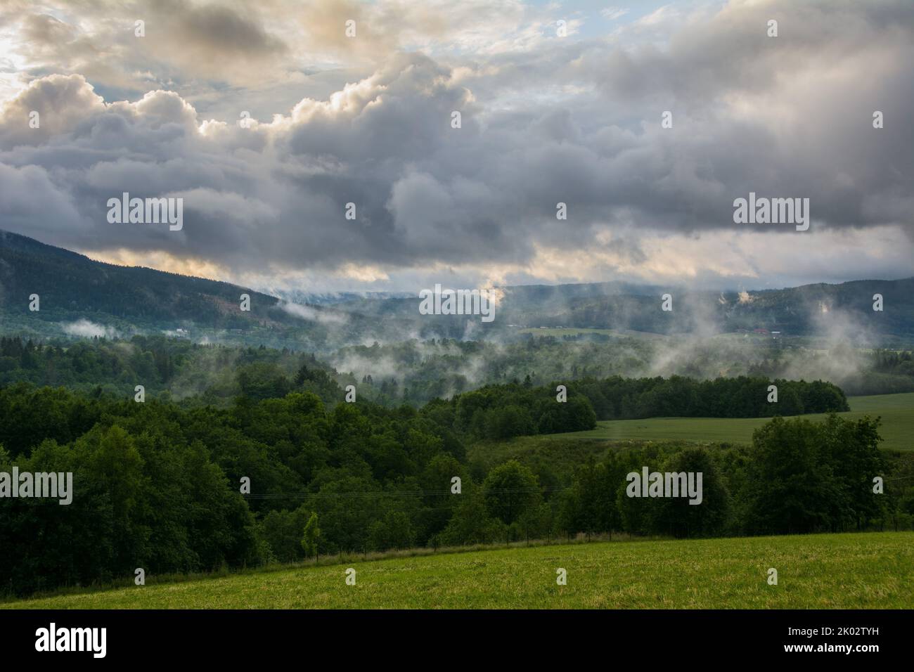 The beautiful view of forested mountains and a cloudy sky after a rainstorm in Lier valley, Norway Stock Photo