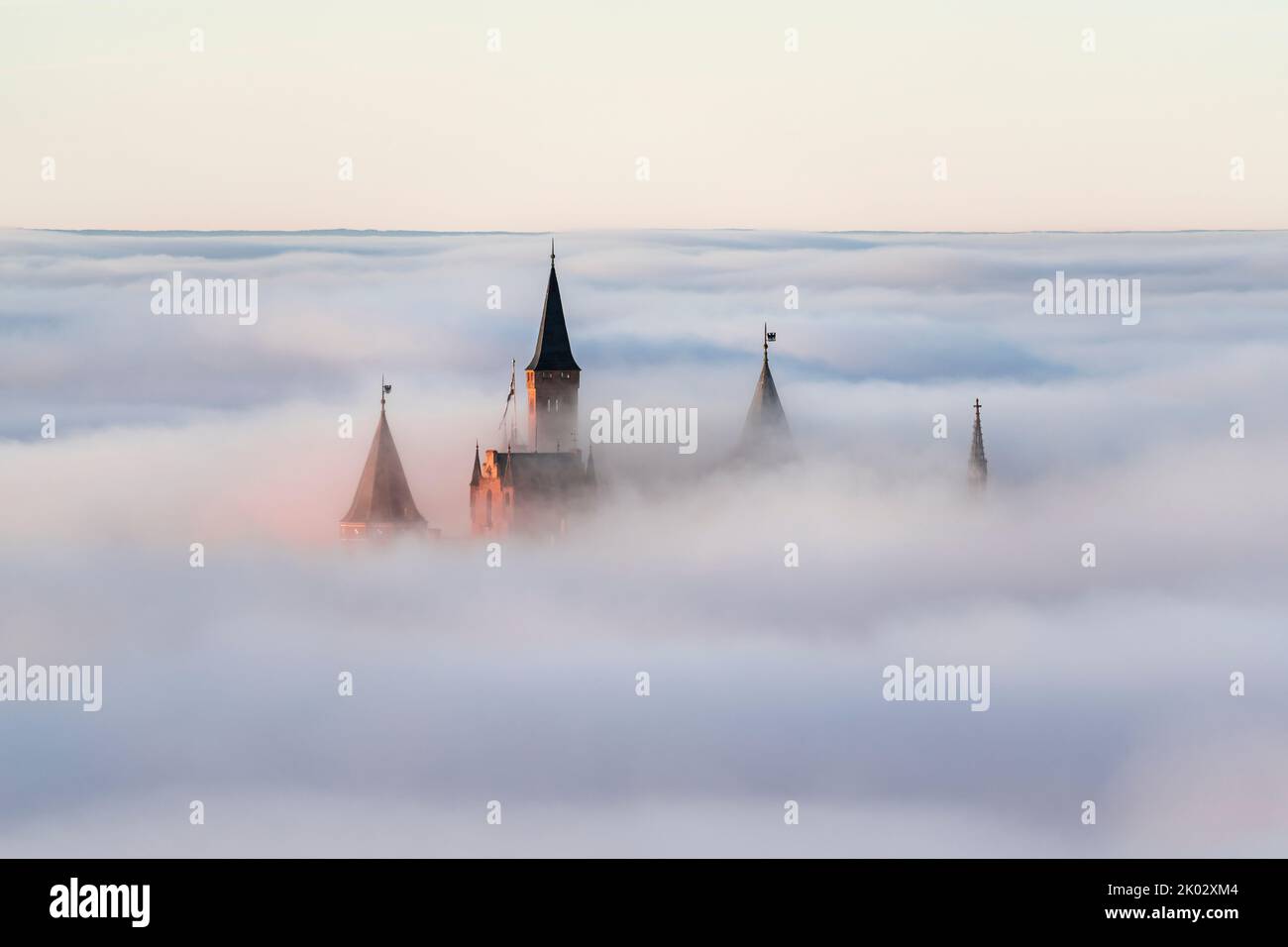 Hohenzollern Castle sunk in sea of fog, sunset, Swabian Alb, Baden-Württemberg, Germany Stock Photo