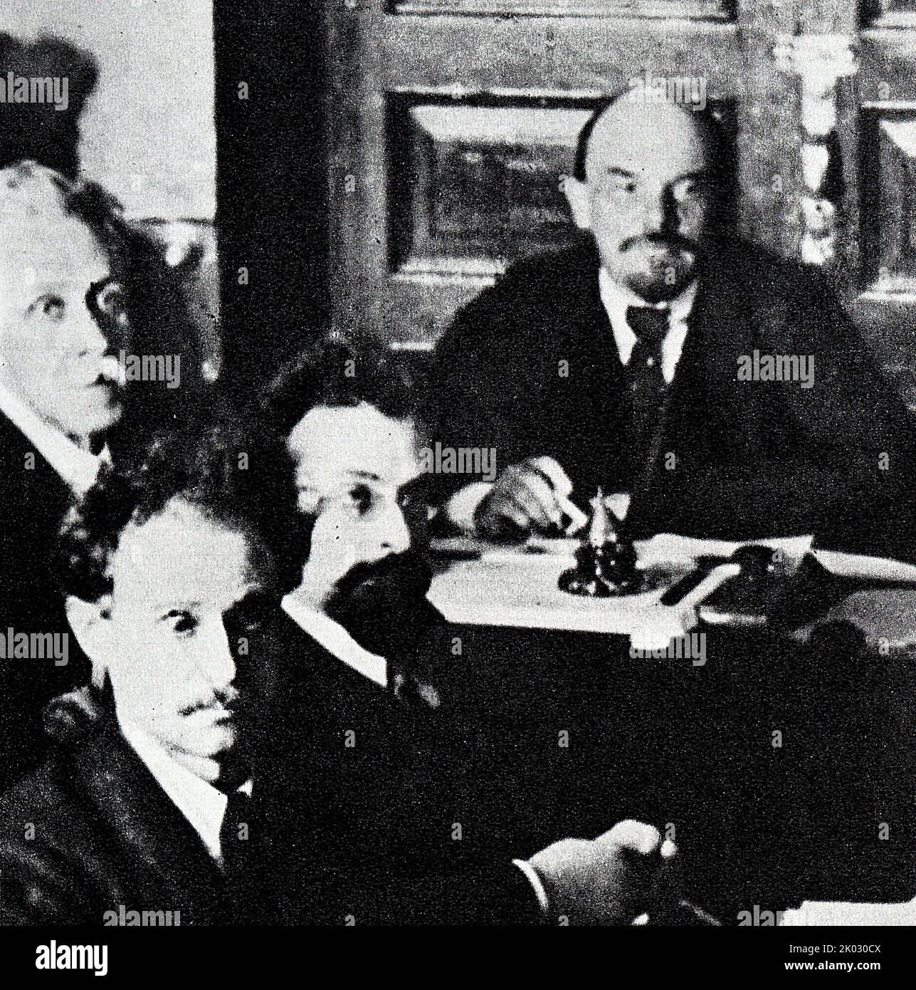 Vladimir Lenin in the Kremlin presides over a meeting of the Council of People's Commissars for recovery from injury. 1918, Moscow. Photographer - Otsup P. A. Stock Photo