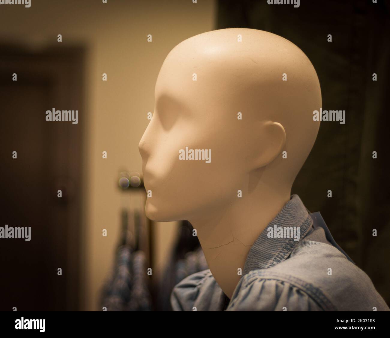 A closeup shot of a mannequin's head in a clothing shop with a blur background Stock Photo