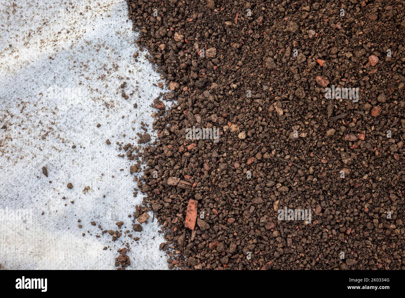 Mülheim an der Ruhr, North Rhine-Westphalia, Germany, flat roof is prepared for green roof. Here, the substrate layer is applied to the separating fleece to the drainage layer below. Stock Photo