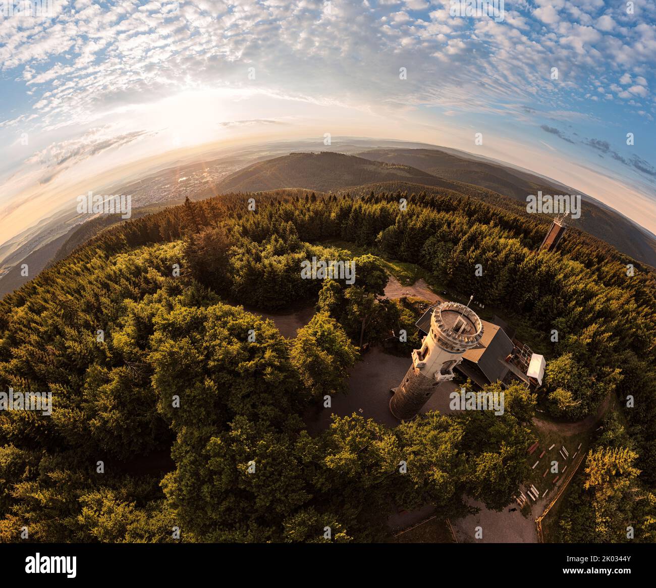 Germany, Thuringia, Ilmenau, Kickelhahn, lookout tower, restaurant, telecom tower (background), sunrise, forest, mountains, hemisphere panorama Stock Photo