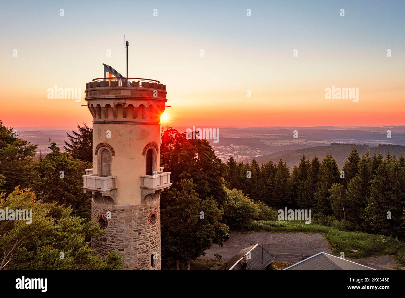 Germany, Thuringia, Ilmenau, Kickelhahn, lookout tower, city, forest, mountains, sunrise, backlight Stock Photo