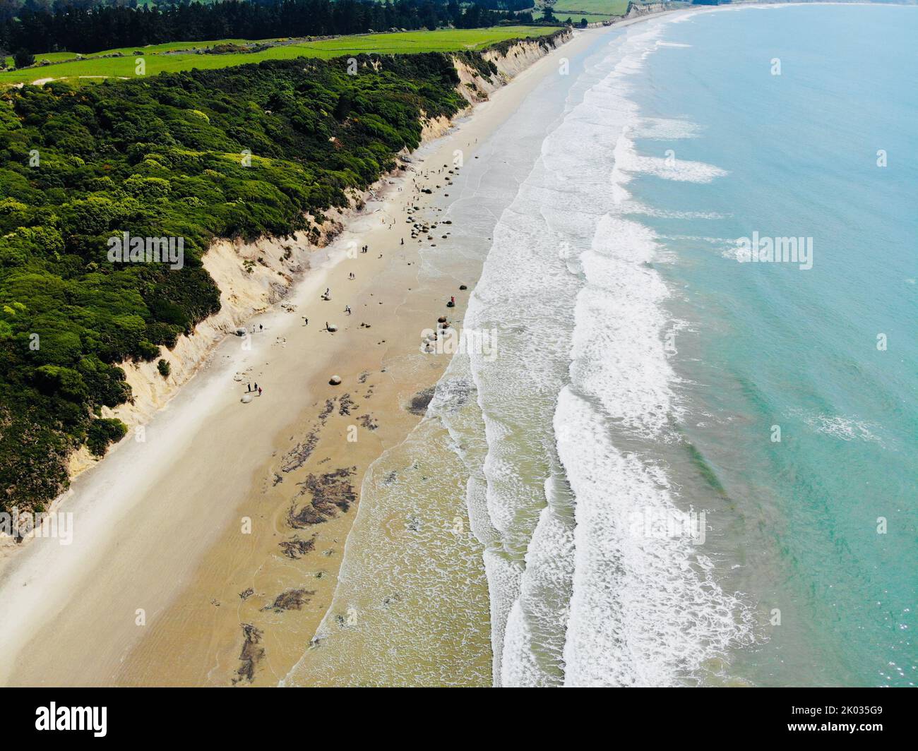 An aerial view of soft ocean waves with foam on a sandy beach Stock ...
