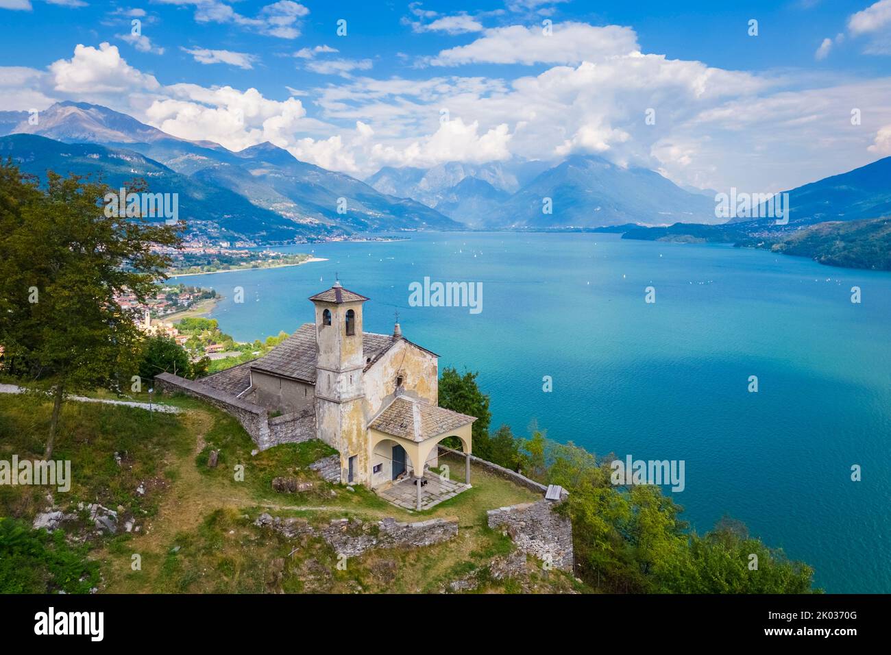 Aerial view of the church of Sant'Eufemia in Musso overlooking Lake Como. Musso, Como district, Lake Como, Lombardy, Italy. Stock Photo