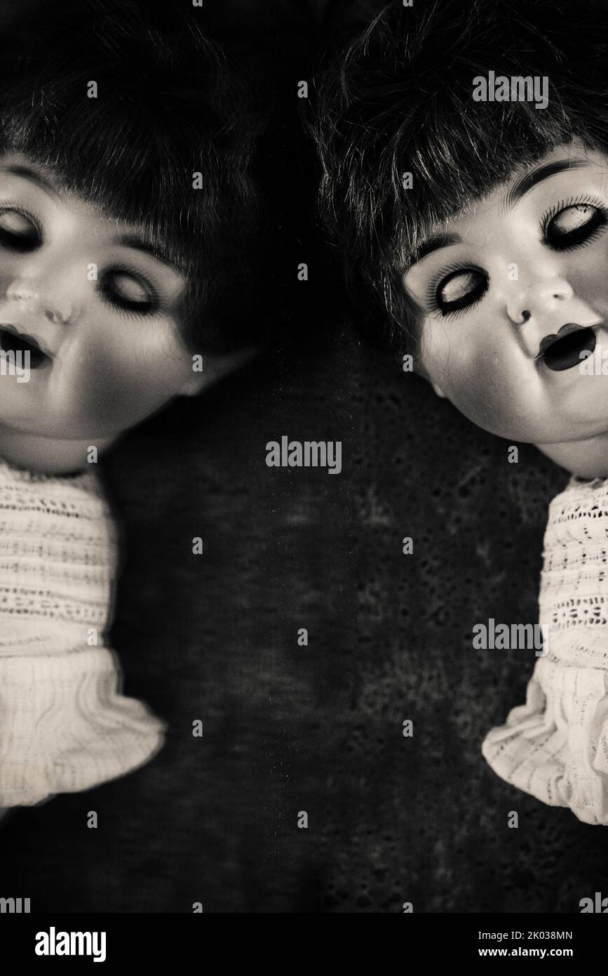 Old fashioned doll with mirror image Stock Photo
