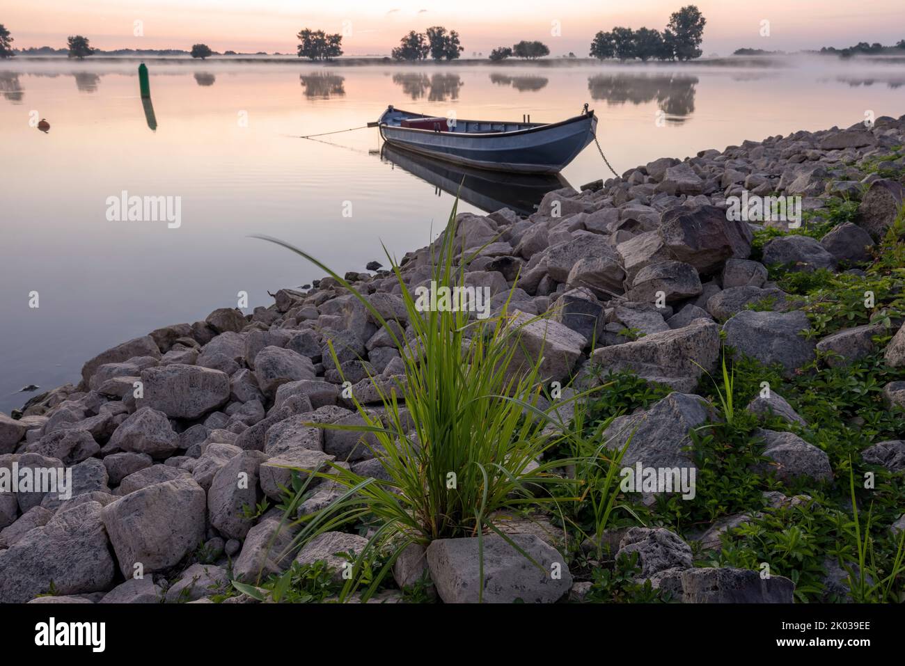View of the Elbe in the early morning and a boat on the shore Stock Photo
