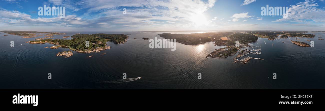 Norway, Vestfold og Telemark, Larvik, fjord, islands, pleasure boats, jetties, Larvikfjord, houses, forest, rocky shore, Malmoya (island), Stavern (background), rope forening, sun, overview, aerial view, partly backlight, 360° panorama Stock Photo