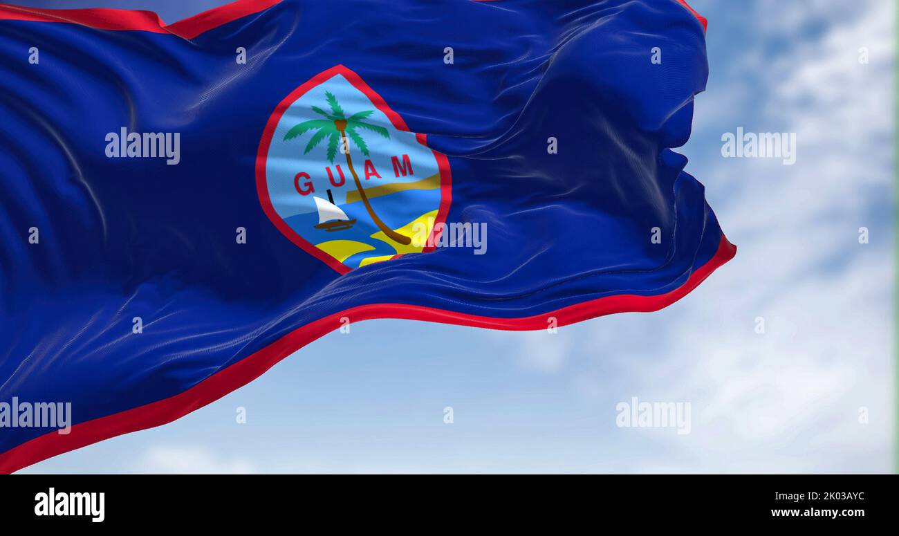 Flag of Guam waving in the wind on a clear day. Guam is an organized, unincorporated territory of the United States in the Micronesia subregion of the Stock Photo