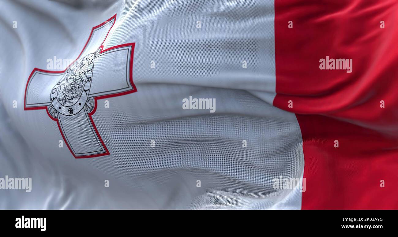 Close-up view of the Maltese national flag waving in the wind. The Republic of Malta is an island country in the Mediterranean Sea. Fabric textured ba Stock Photo