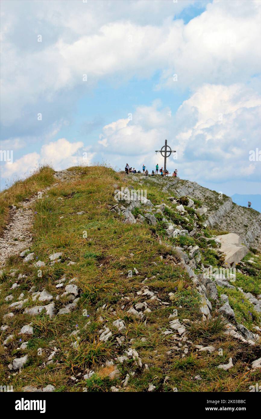 View to the Seekarspitze (2053m) with summit cross, hiker at summit rest, at the Achensee, alpine panorama, Tyrol, Austria Stock Photo