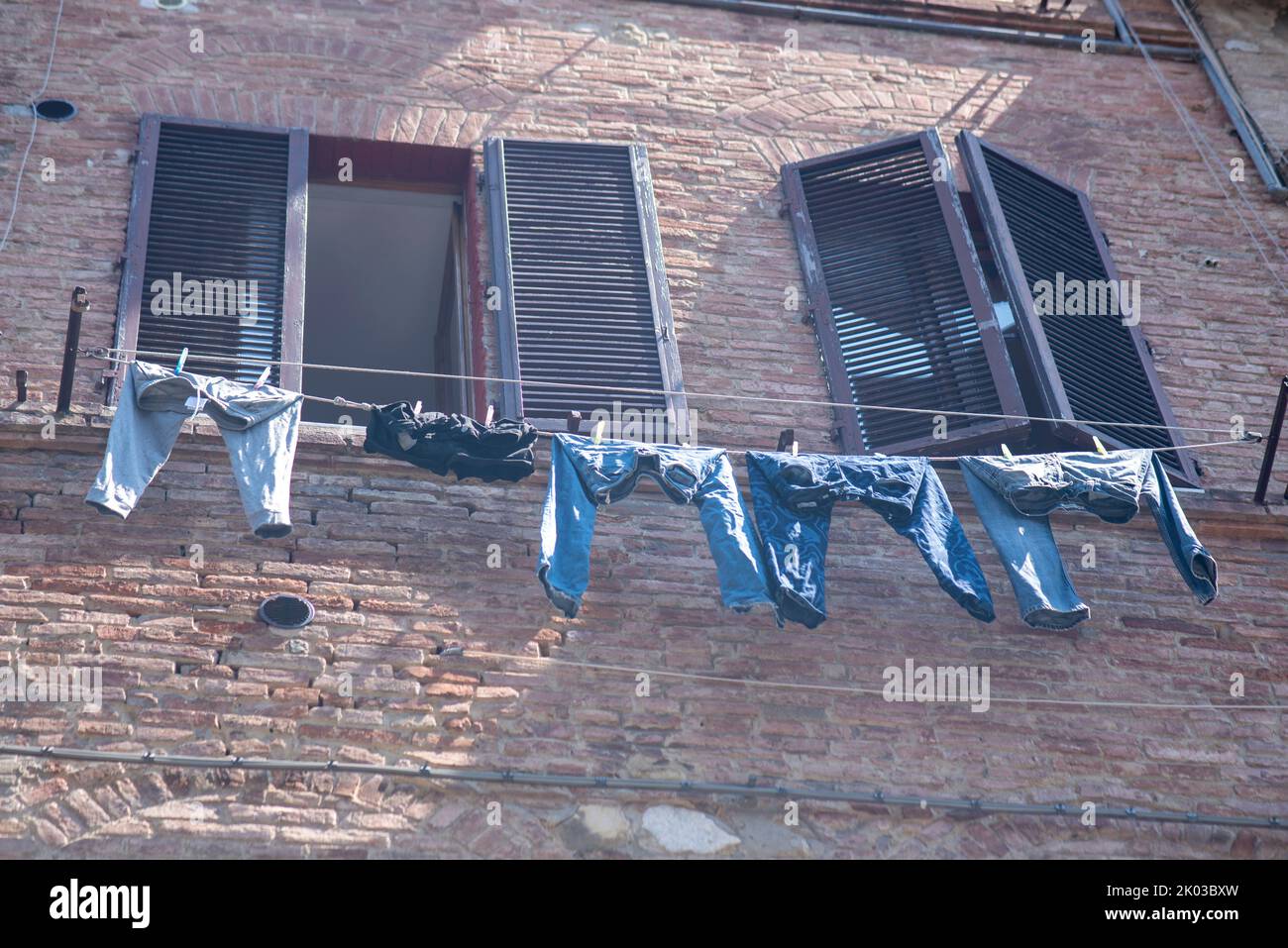 Laundry in front of a window, Siena, Tuscany, Italy Stock Photo