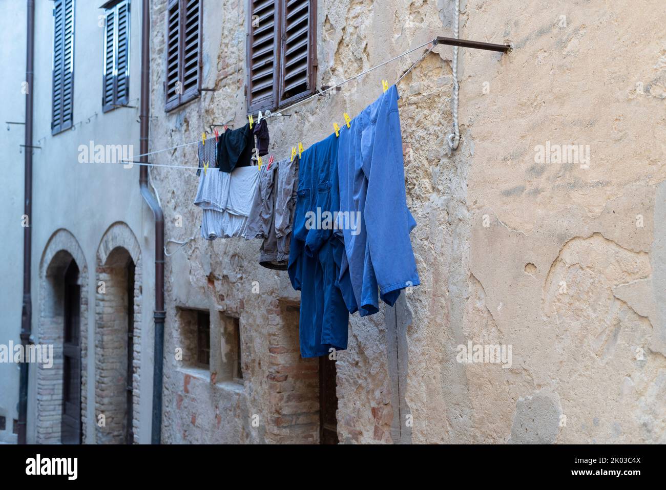Laundry hanging to dry on a house wall, Castiglione della Pescaia, Grosseto province, Tuscany, Italy. Stock Photo
