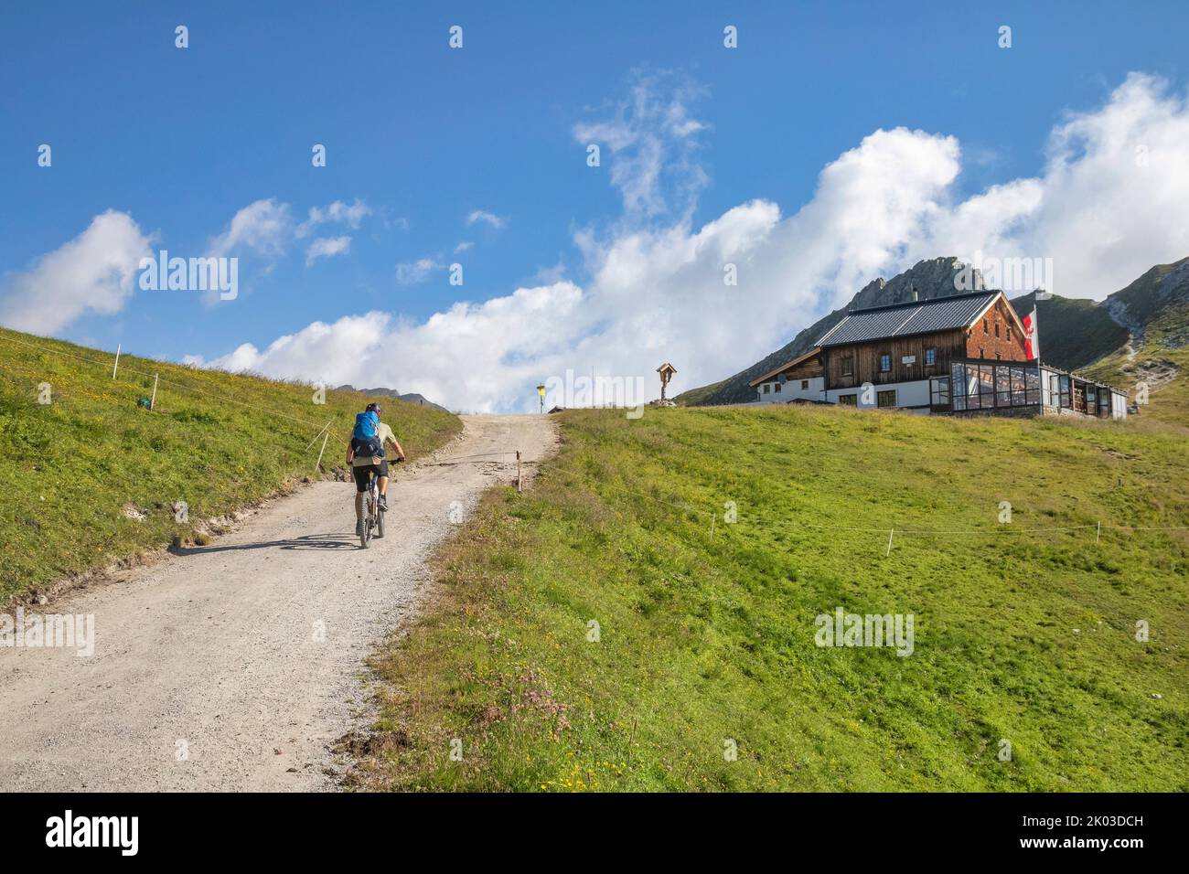 Austria, Tyrol, Alps of Tux. a man riding an e-bike (emtb) uphill to the Tuxerjoch, Tuxerjoch-haus, Hintertux Stock Photo