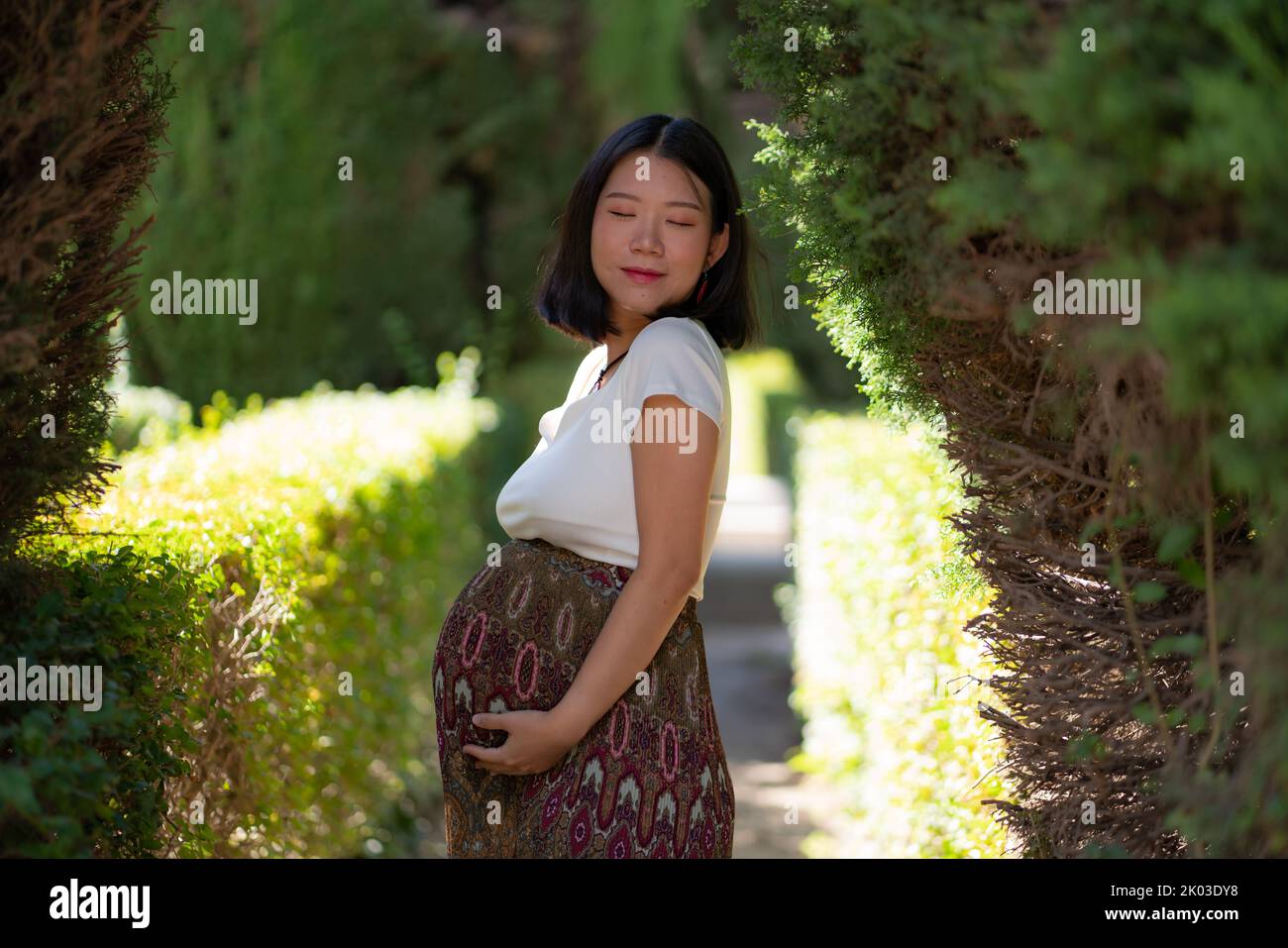 young happy and beautiful Asian Korean woman posing outdoors happy and