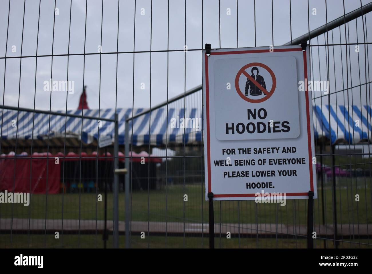 Sign at a festival in Campbell Park Milton Keynes: 'No hoodies. For the safety and well being of everyone please lower your hoodie' with copy space. Stock Photo