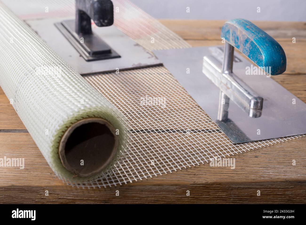 Fiberglass Reinforcing Plastering Mesh used for plaster work with rectangular trowel Stock Photo