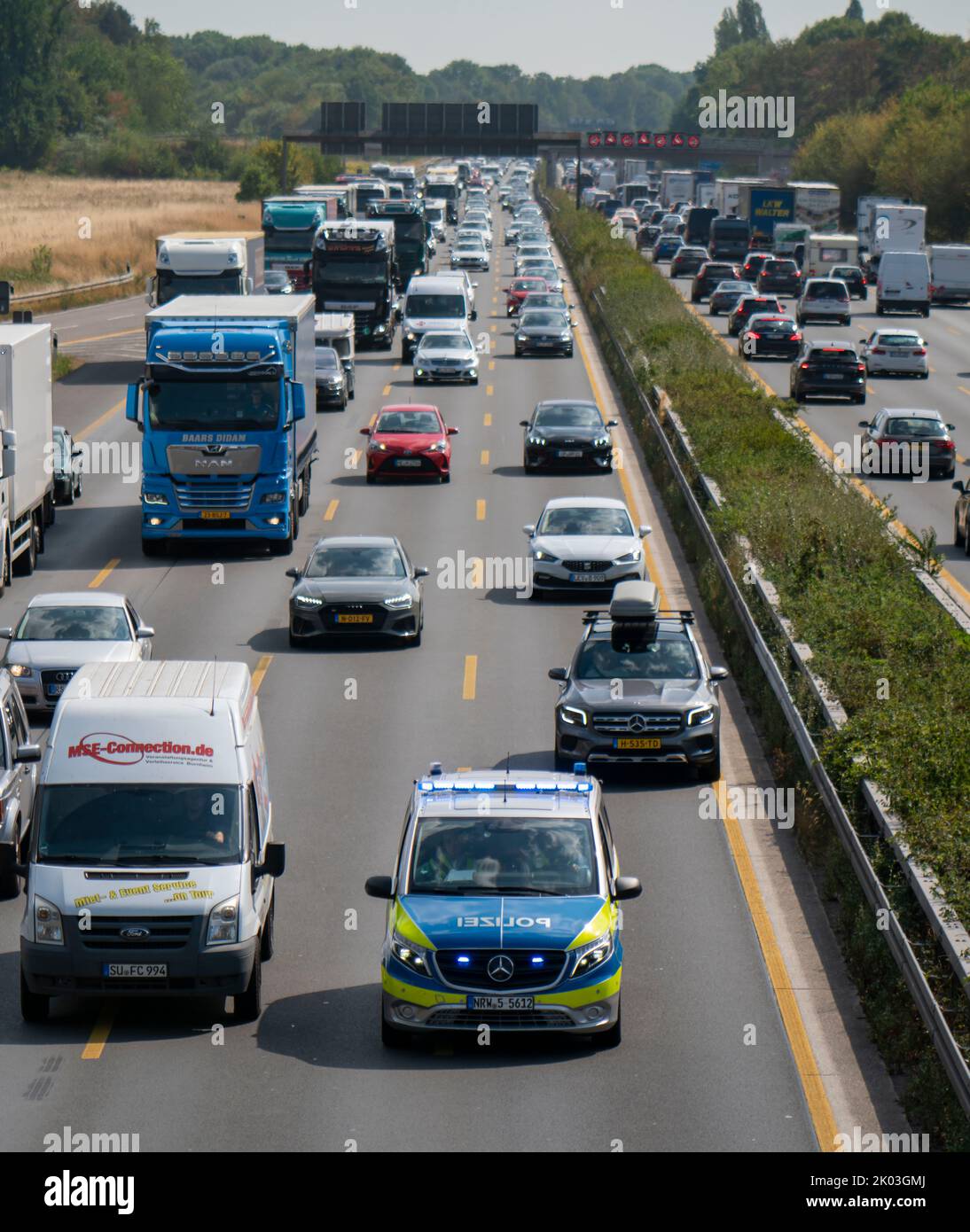 Police patrol car works its way through a traffic jam on the A3
