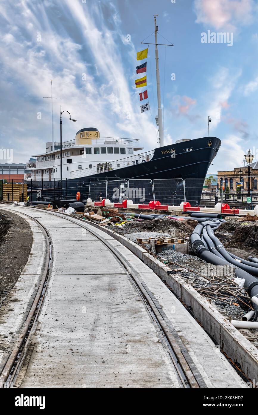 Floating luxury hotel ship Fingal by tram track during tram line construction work, Leith, Edinburgh, Scotland, UK Stock Photo