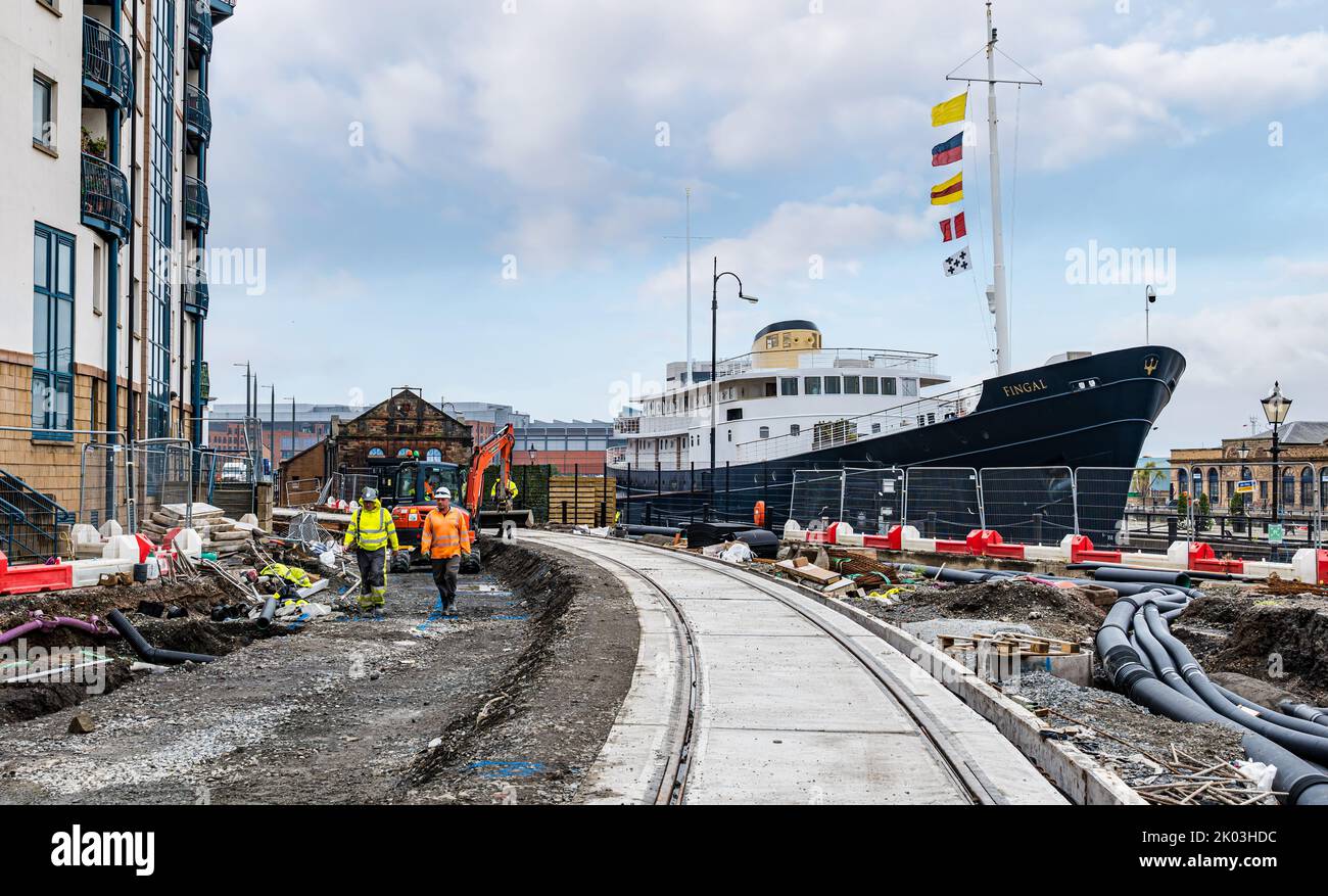 Floating luxury hotel ship Fingal by tram track during tram line construction work, Leith, Edinburgh, Scotland, UK Stock Photo