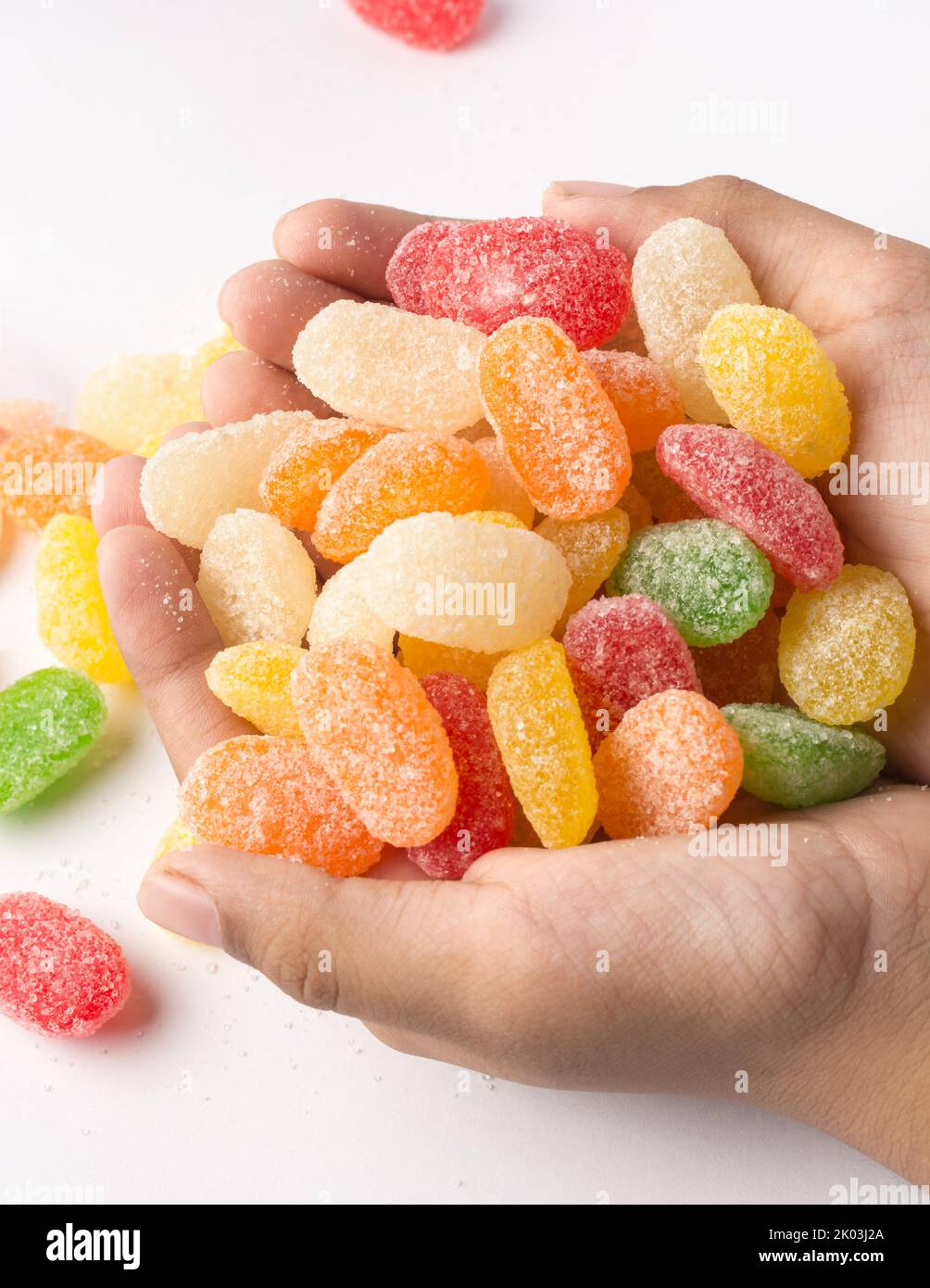 handful of jujube, colorful gummy type of candy confectionery isolated on white background, soft-focus Stock Photo