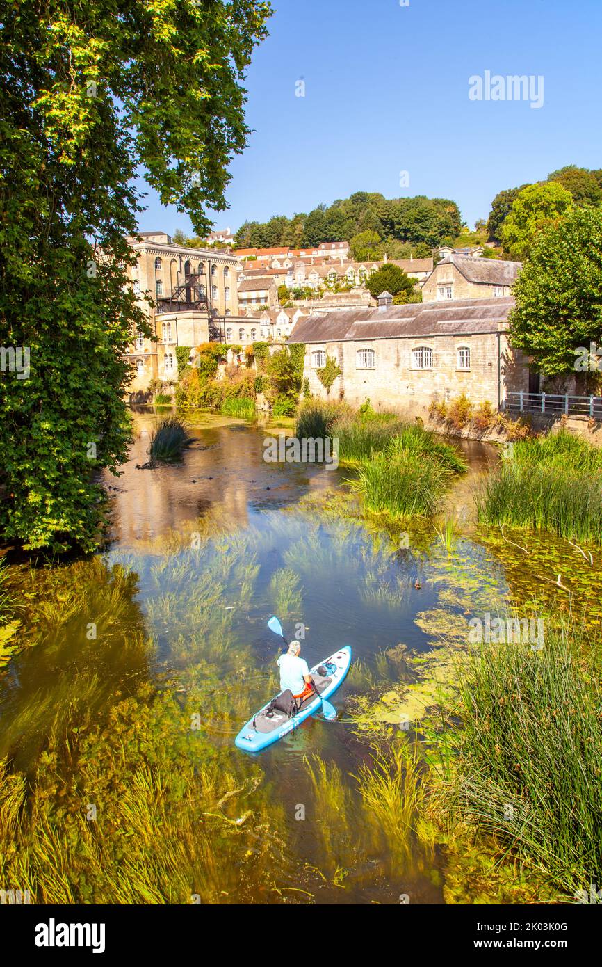 Man canoeing kayaking on  the river Avon as it passing through the Wiltshire market town of Bradford on Avon  Wiltshire England Stock Photo