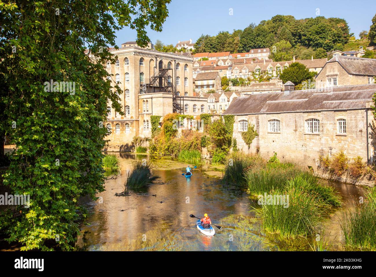 Men canoeing kayaking on  the river Avon as it passing through the Wiltshire market town of Bradford on Avon  Wiltshire England Stock Photo