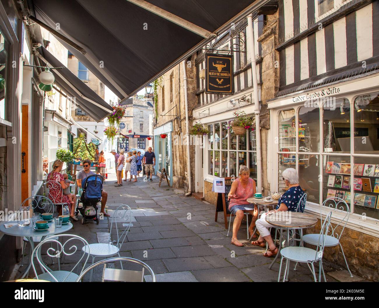 People sitting eating and drinking at cafes in the Shambles in the Wiltshire market town of Bradford on Avon Stock Photo