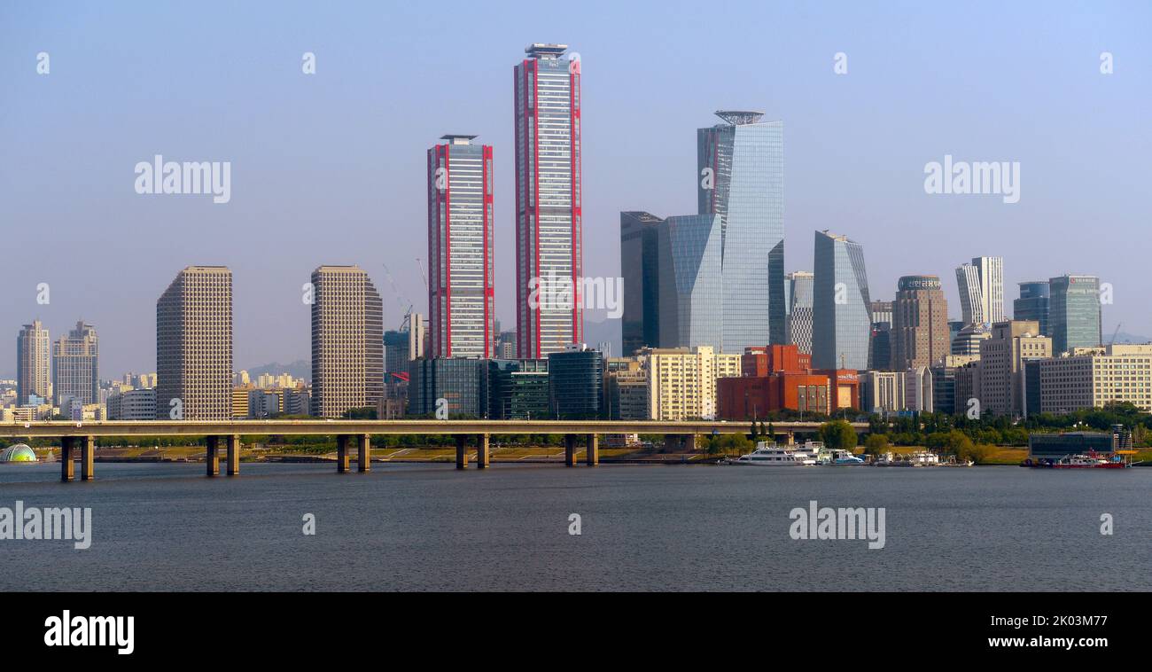 View across the Hangang River. 'The Parc 1 Tower (with red piping), is a supertall skyscraper in Seoul, South Korea. It stands 333 m (1,093 ft) and contain 69 floors. Construction stopped in 2011 but resumed in early 2017. Seoul, South Korea Stock Photo