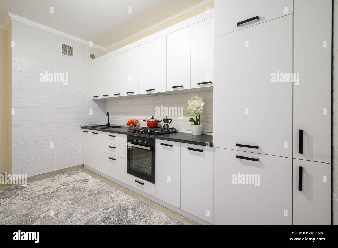 Trendy white modern kitchen interior with minimalistic furniture Stock Photo