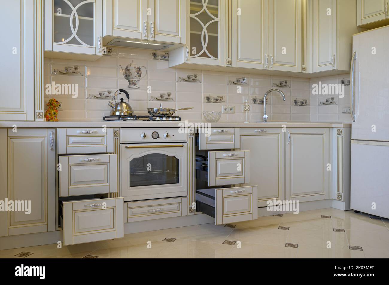 Classic white and beige kitchen furniture in studio apartment Stock Photo