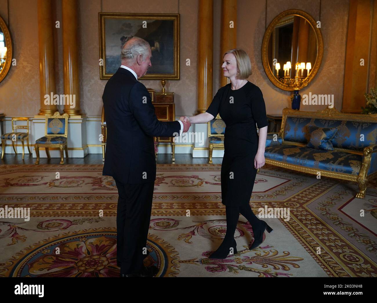King Charles III shakes hands with Prime Minister Liz Truss during