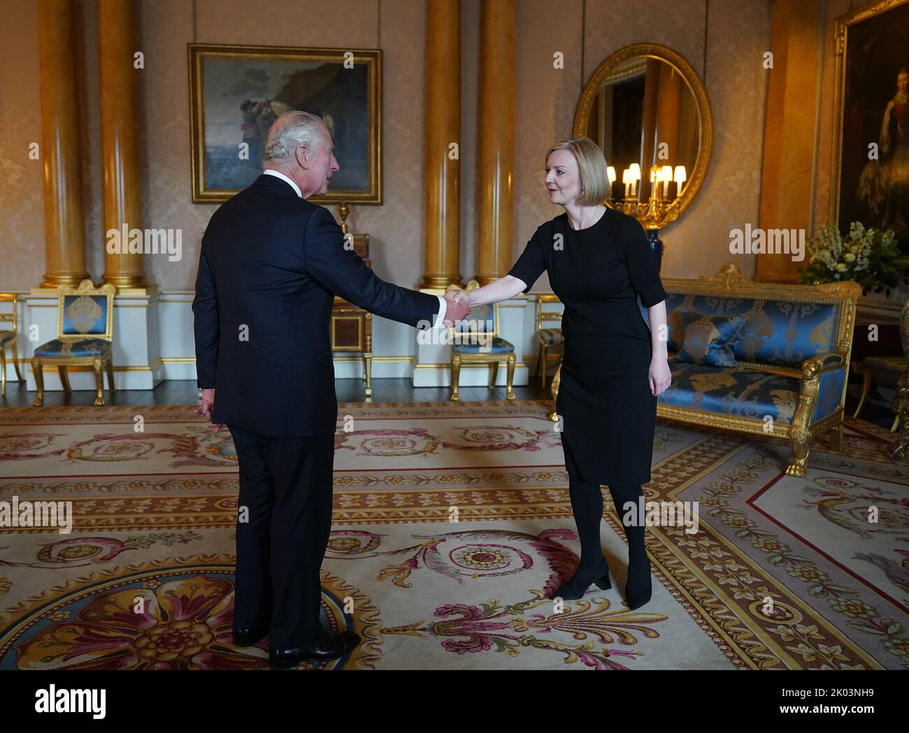 King Charles III shakes hands with Prime Minister Liz Truss during
