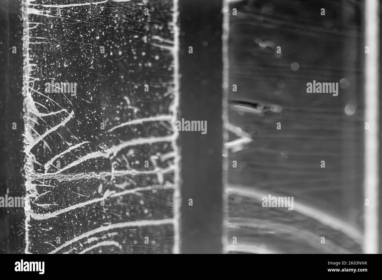 Strip of tape adhesive on a glass surface after being pulled Stock