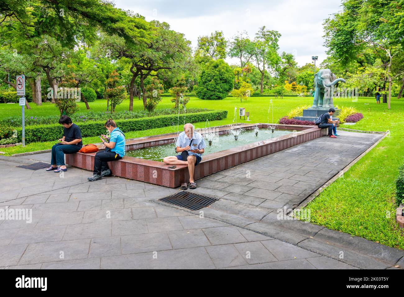 BANGKOK, THAILAND - 1.11.2019: People is playing the Pokemon Go game on cellphone in public park in Bangkok city. Stock Photo