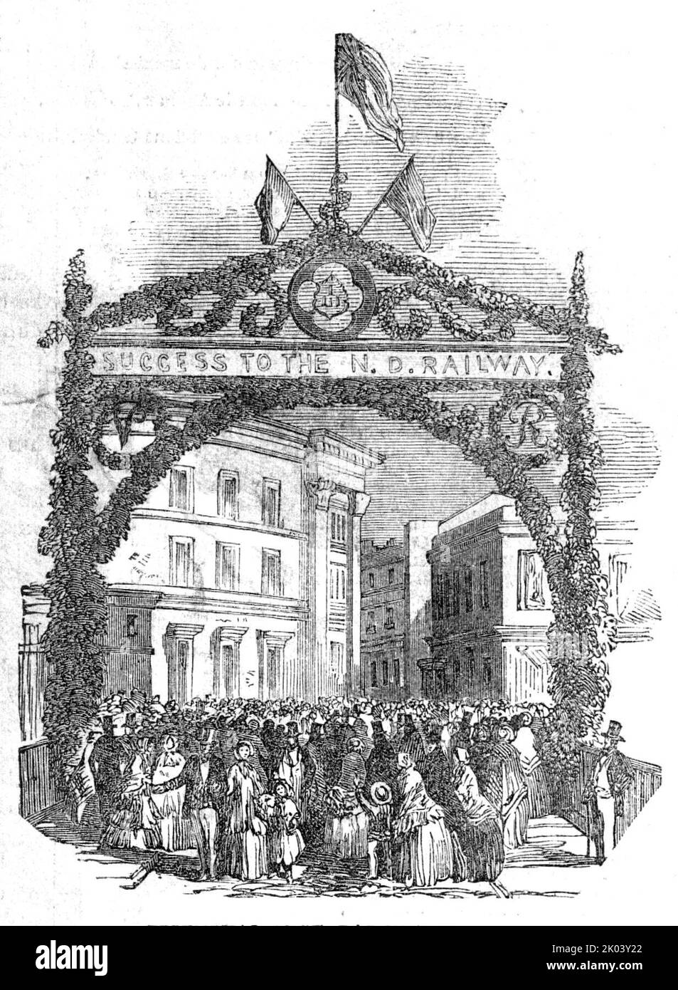 Triumphal Arch, Barnstaple-Bridge, 1854. Celebrations at the opening of the North Devon Railway. Festal arch with sign reading: 'Success to the N. D. Railway'. 'The day was set aside for general rejoicing throughout the whole district...A procession, headed by a troop of the North Devon Mounted Rifles, then formed, which included the Mayors and Town-councils of Exeter, Barnstaple, Bideford, Torrington, Southmolton, the Lodge of Odd Fellows and Freemasons, trades unions, railway directors, magistrates and gentry of the county, accompanied by several bands of music, and appropriate flags, banner Stock Photo