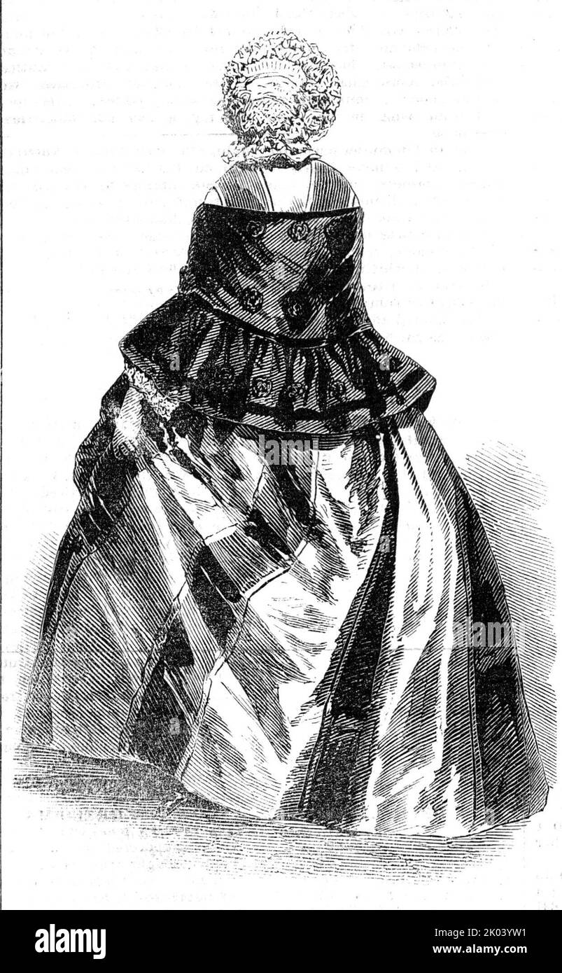 Paris Fashions for October, 1854. 'Bonnet of Rice-straw and Blonde; poplin dress, with wide stripes ; sarcenet scarf-mantilla, ornamented with stamped rounds, and trimmed with guipure or net; the material of the mantilla being fastened together by chain-stitch. The summer mantillas, for some time past, have been so made that they may suit the season which is advancing; the colour of the sarcenet is darker, and the open embroidery diminished'. From &quot;Illustrated London News&quot;, 1854. Stock Photo
