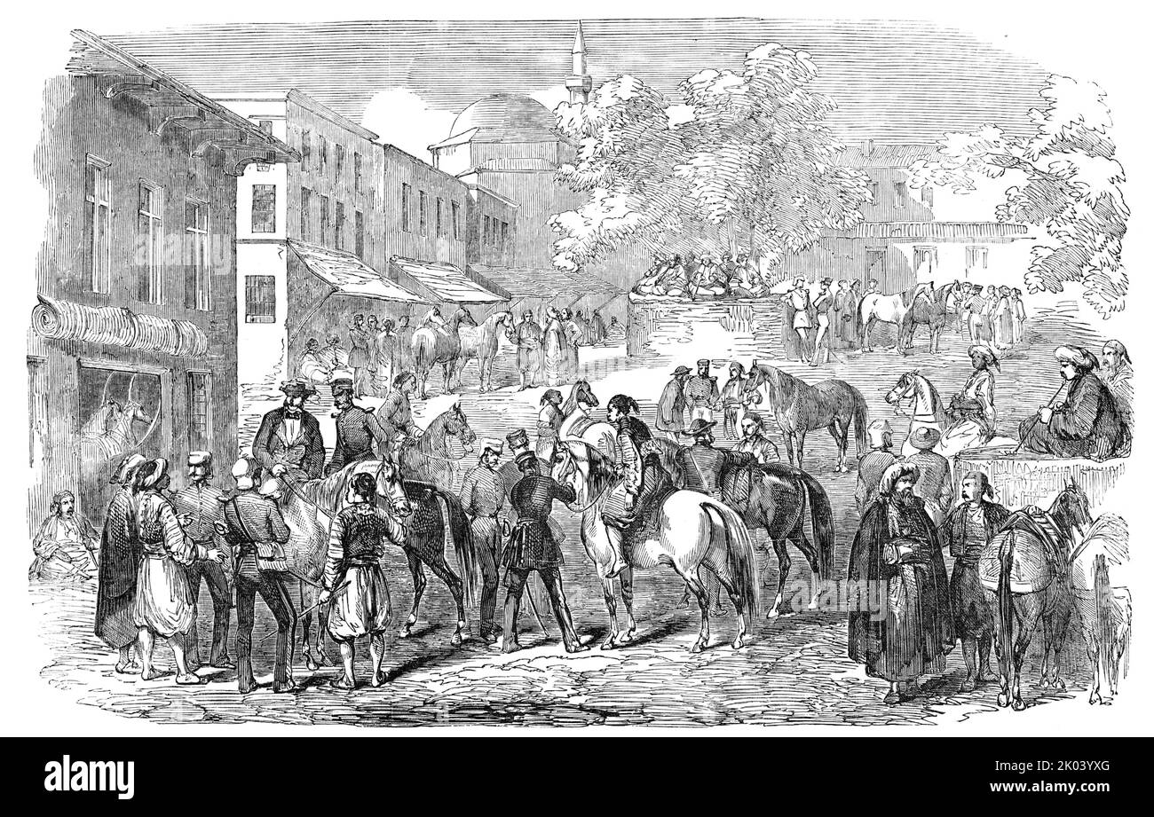 Horse Bazaar, at Constantinople, 1854. Scene during the Crimean War. 'One of the busy scenes in the Turkish capital during the encampment of the British troops in the suburbs, was the Horse Bazaar, sketched by our Artist. It is, certainly, a much more picturesque affair than our large building in Baker-street [in London]. The scene represented is a small square, with groups of Turks, smoking; in the foreground are British officers bargaining for and trying horses, mules, &amp;c. About the square are houses which serve for stables...'. From &quot;Illustrated London News&quot;, 1854. Stock Photo
