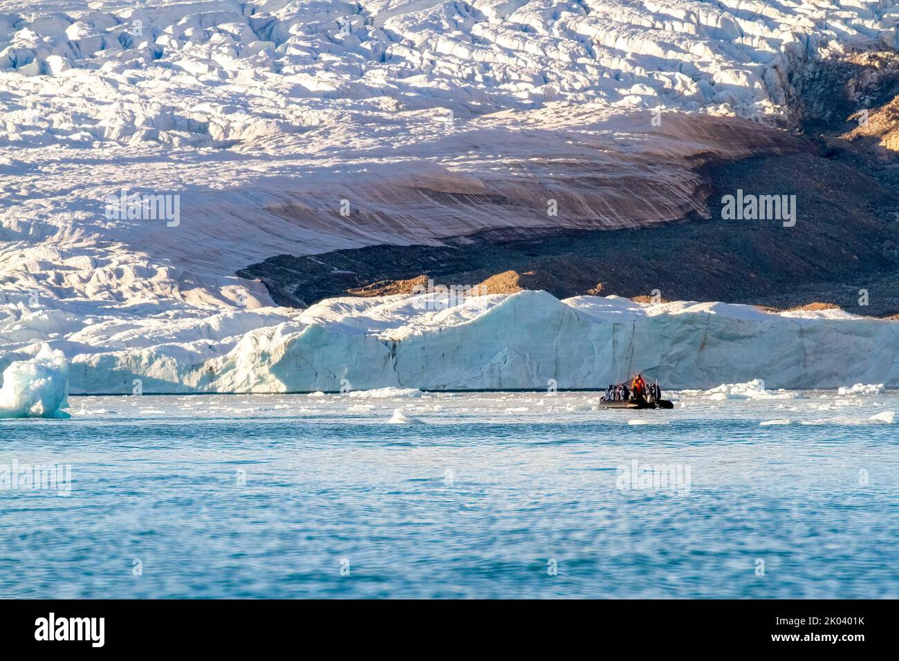 Boat exploring glacier in Croker Bay, Devon Island, Nunavut, Canada. Stock Photo