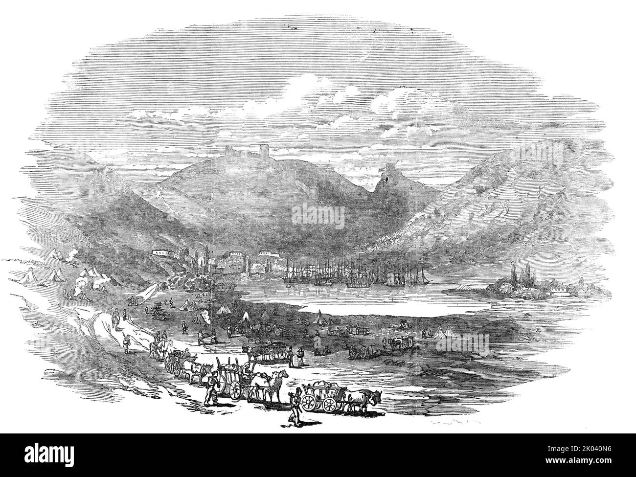Balaclava - view inside the port, 1854. Crimean War. View of the'...inside of the port, which is only accessible through a very narrow circuitous channel, in the form of the letter S. The entrance is not seen at a cannon-shot distance, even when in the bay. The port looks like a pool in a little valley, surrounded by high perpendicular cliffs. On the left of a Genoese fortress (three round towers) lies the town - consisting of one street alongside the shore: it is hidden by the shipping (some sixty large vessels) in the port - a two-decker amongst them. A few houses lie scattered above the hid Stock Photo