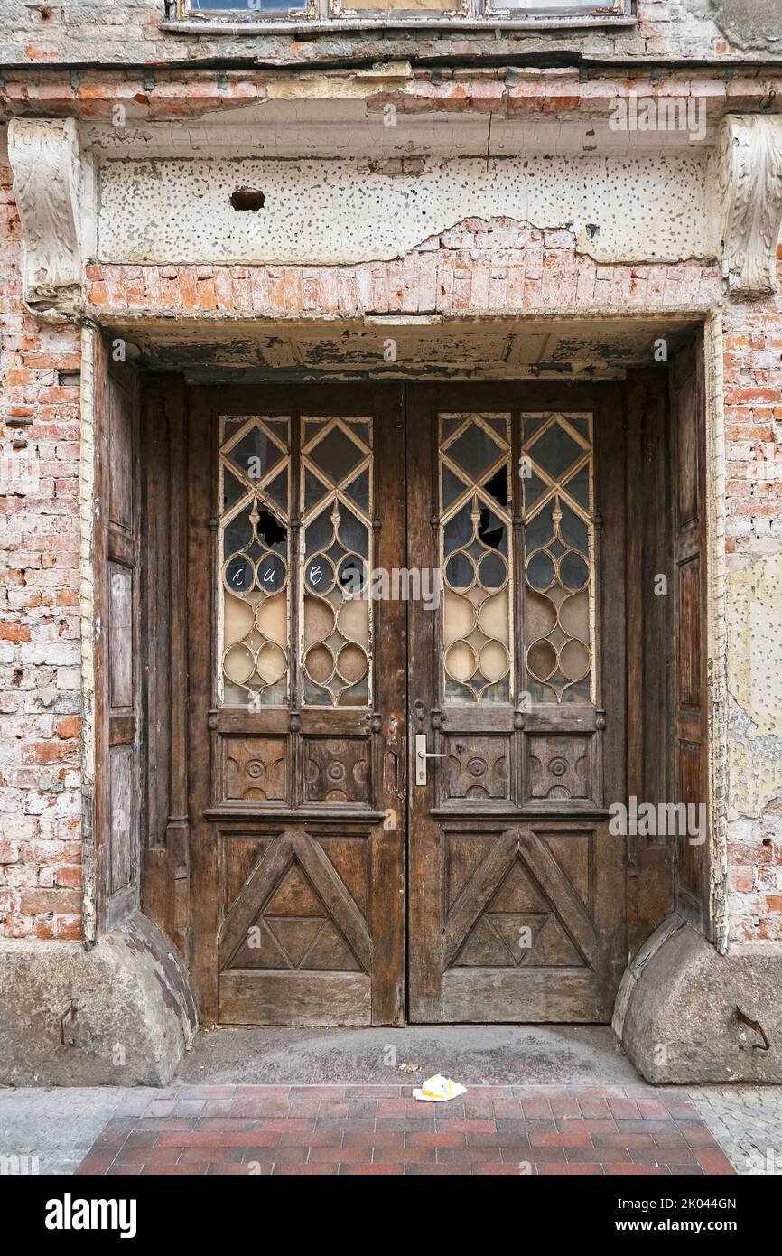 Old shabby double-leaf wooden yard gate, dilapidated listed building of Dankwartstrasse no. 31, Old Town of Wismar, Mecklenburg, Germany. Stock Photo