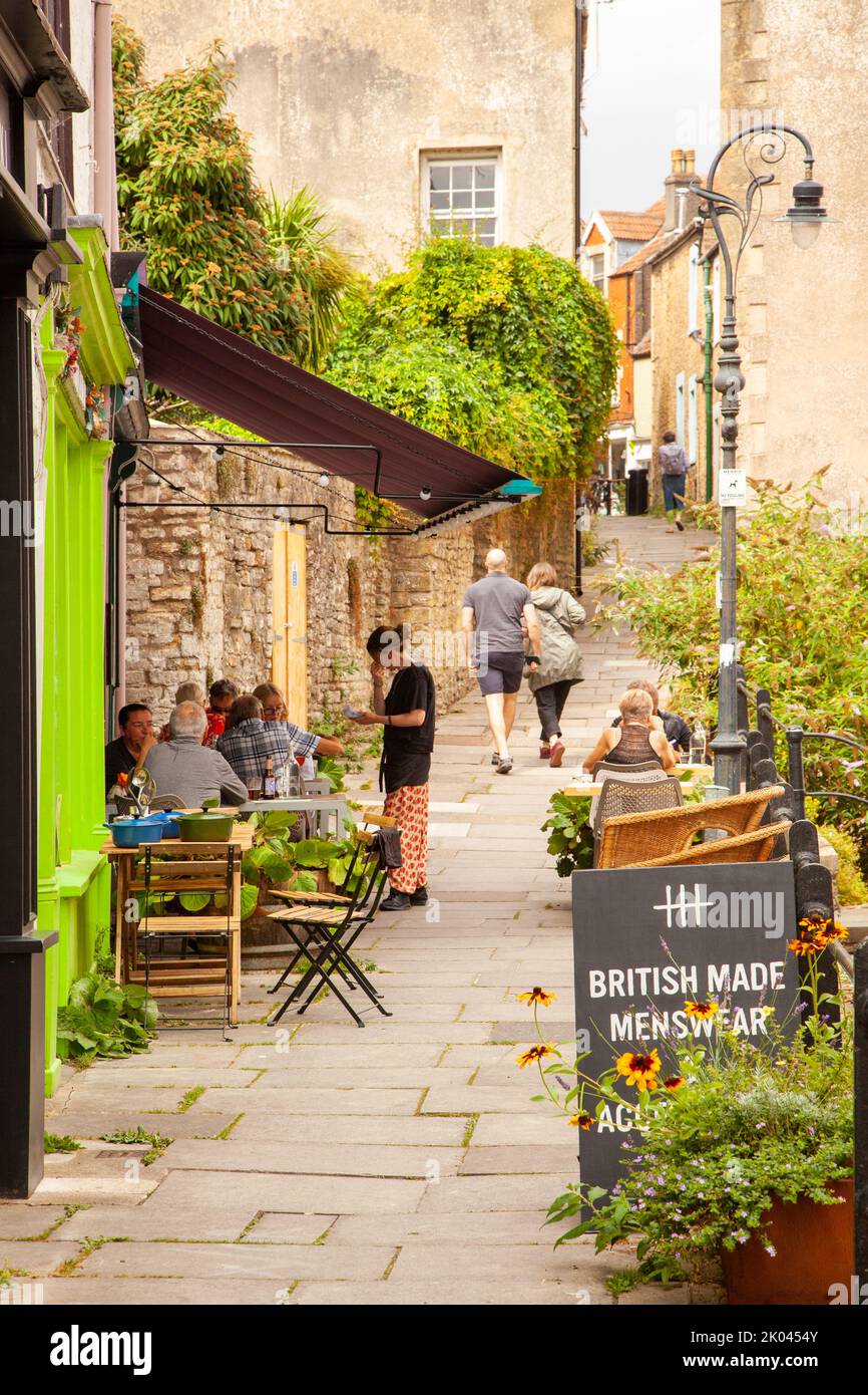 People eating and drinking at outside pavement bistro cafes and wine bars in the Somerset market town of Frome England Stock Photo
