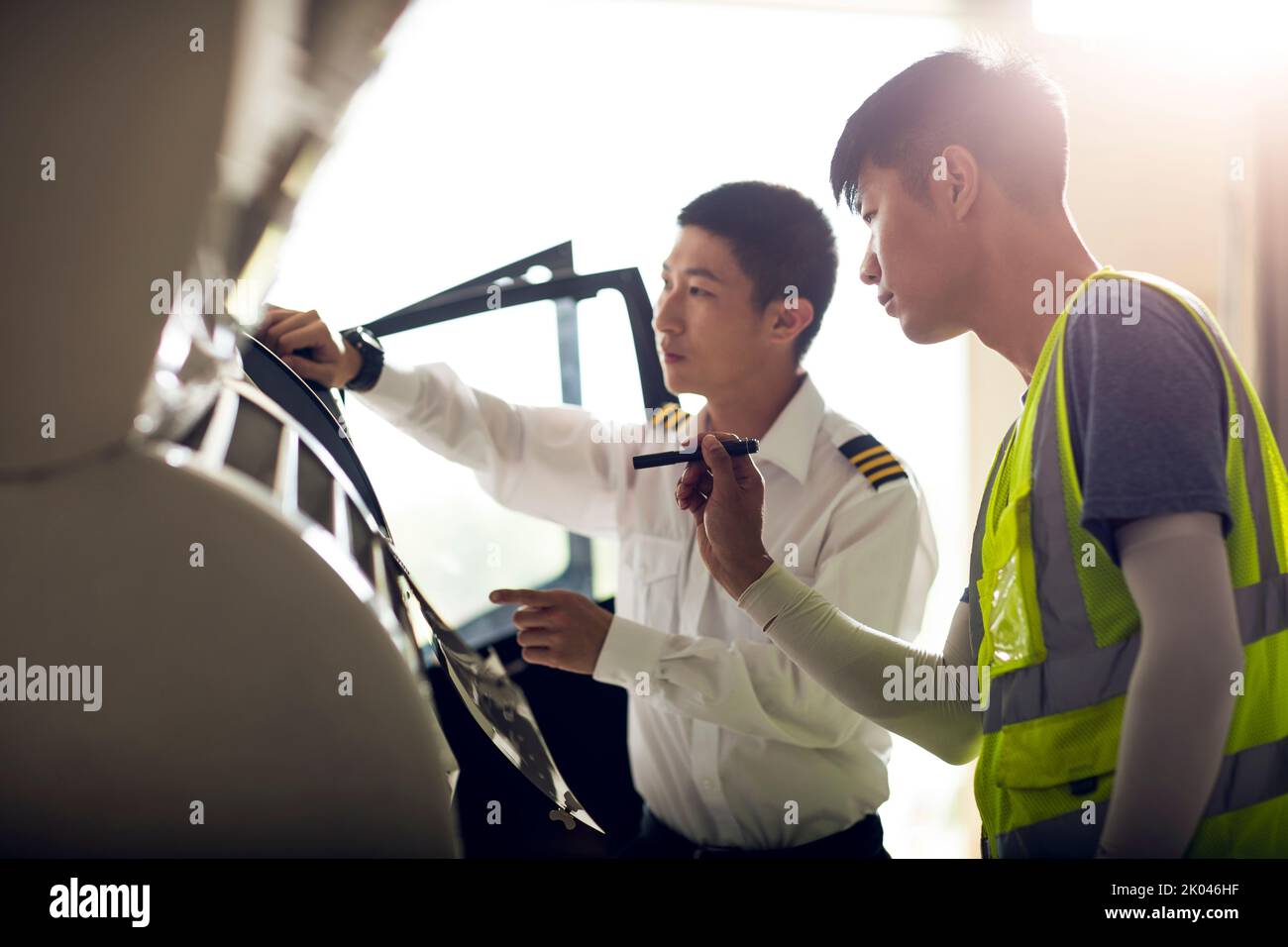 Chinese airplane mechanic checking helicopter Stock Photo