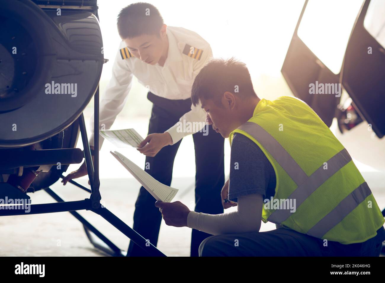 Chinese airplane mechanic checking helicopter Stock Photo