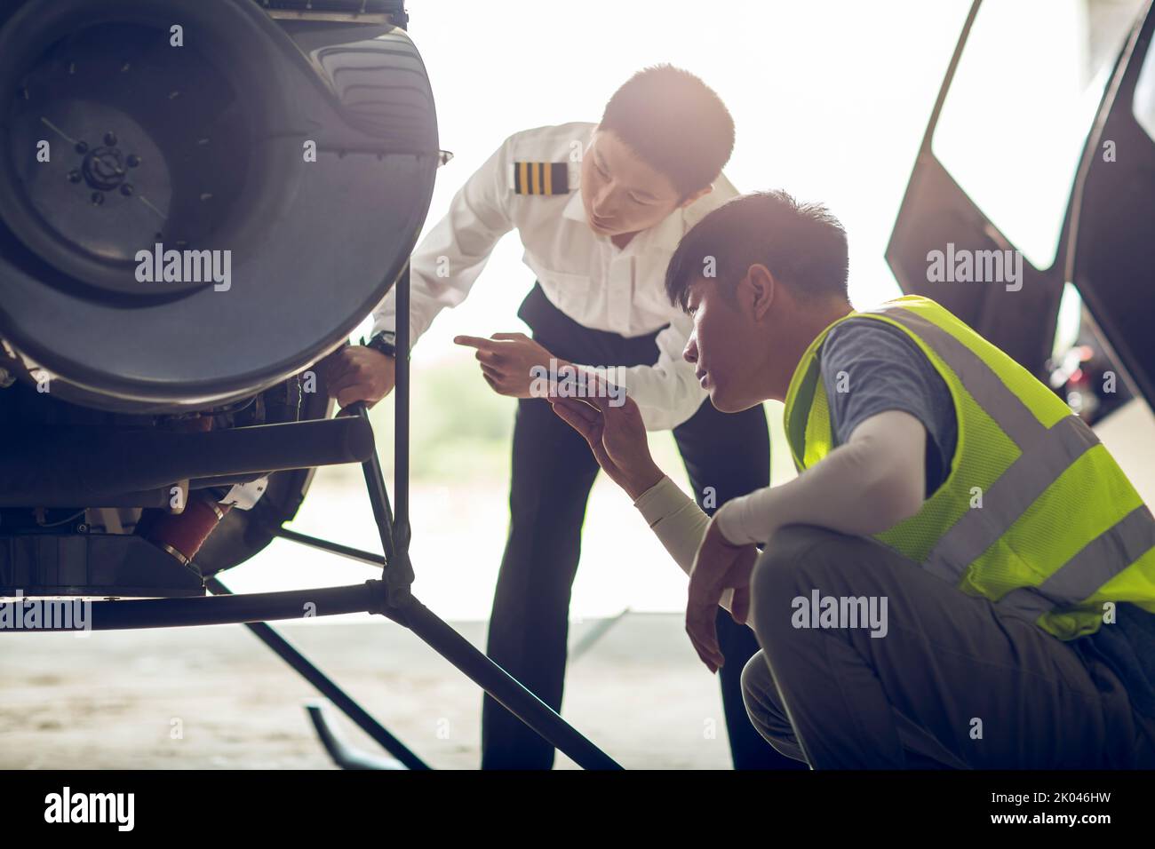 Chinese airplane mechanic checking helicopter Stock Photo