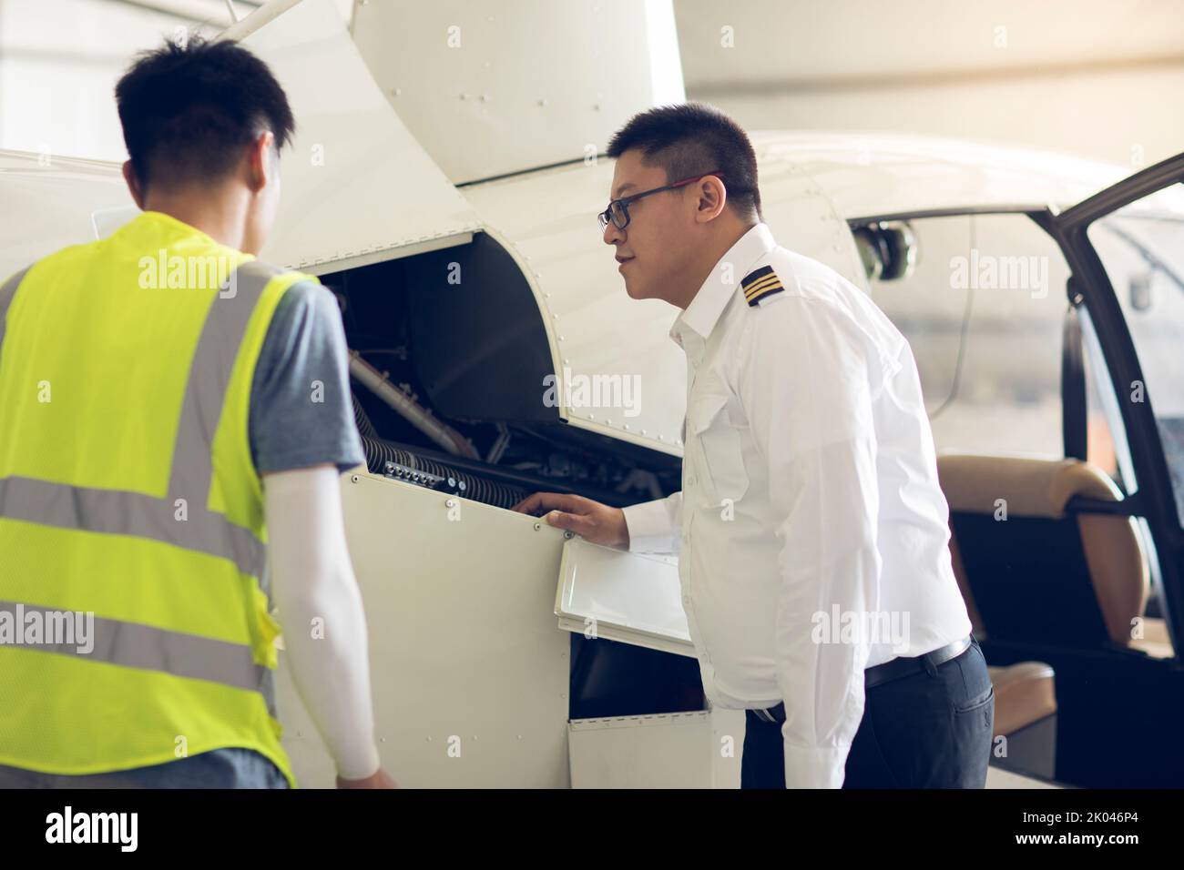 Chinese airplane mechanic checking helicopter Stock Photo