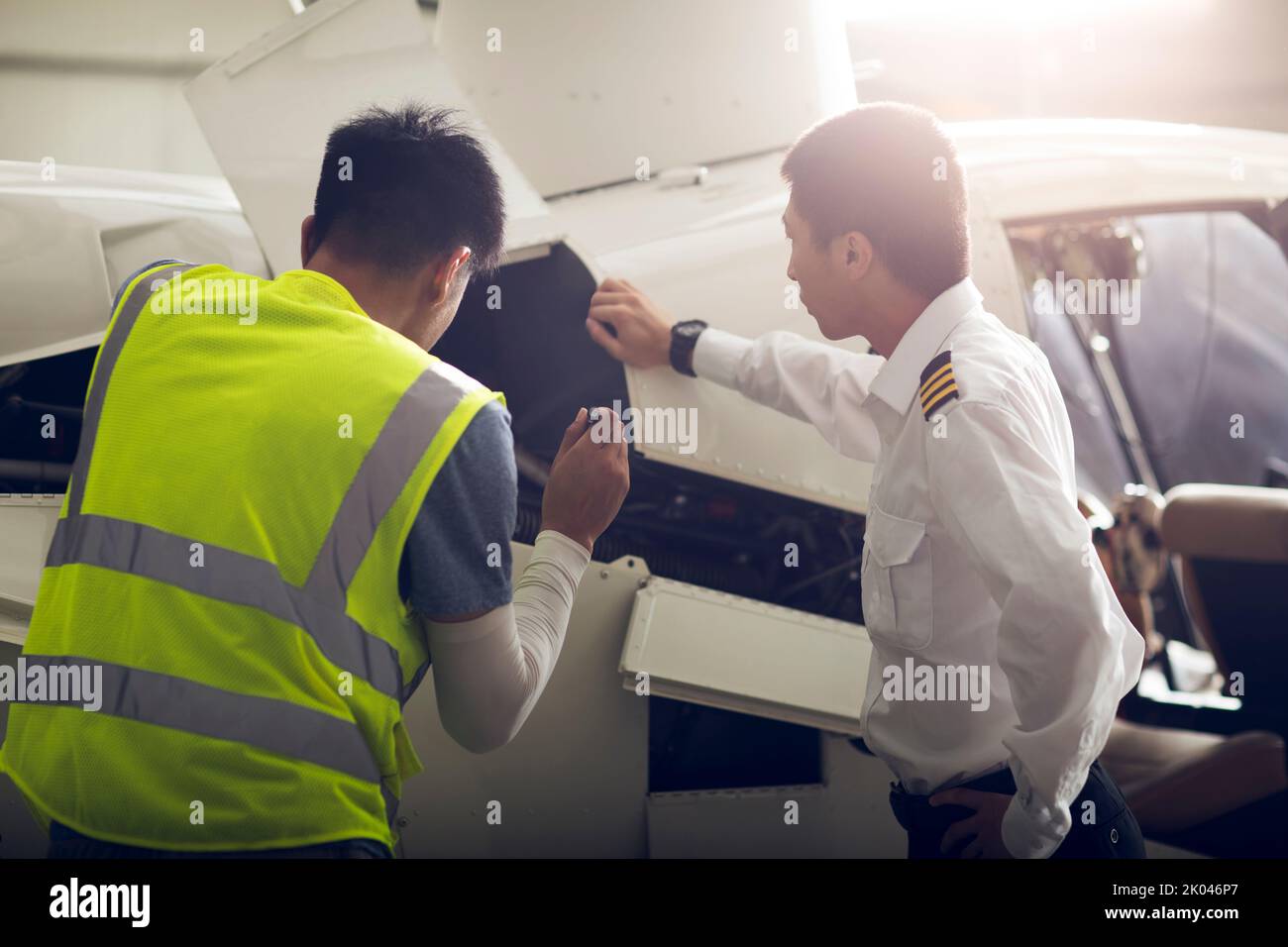 Chinese airplane mechanic checking helicopter Stock Photo