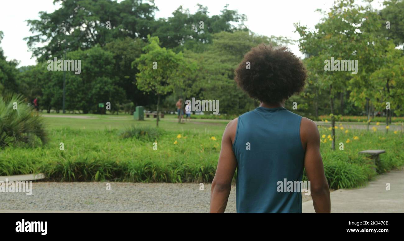 Happy thoughtful african man walking hi-res stock photography and ...