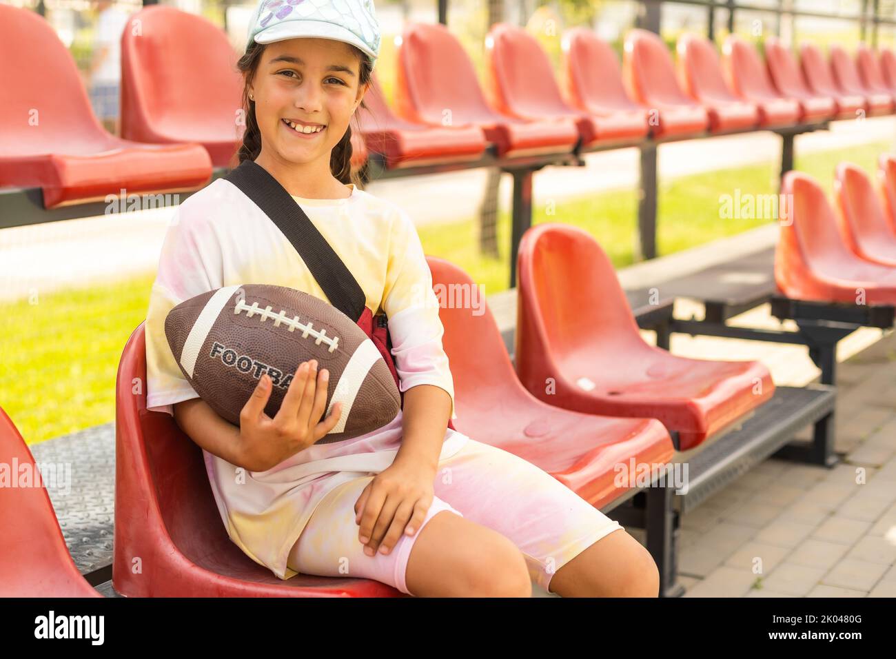 Attractive female american football player in uniform posing with helmet.  girl sportswoman. Gender equality. Copy space Stock Photo - Alamy