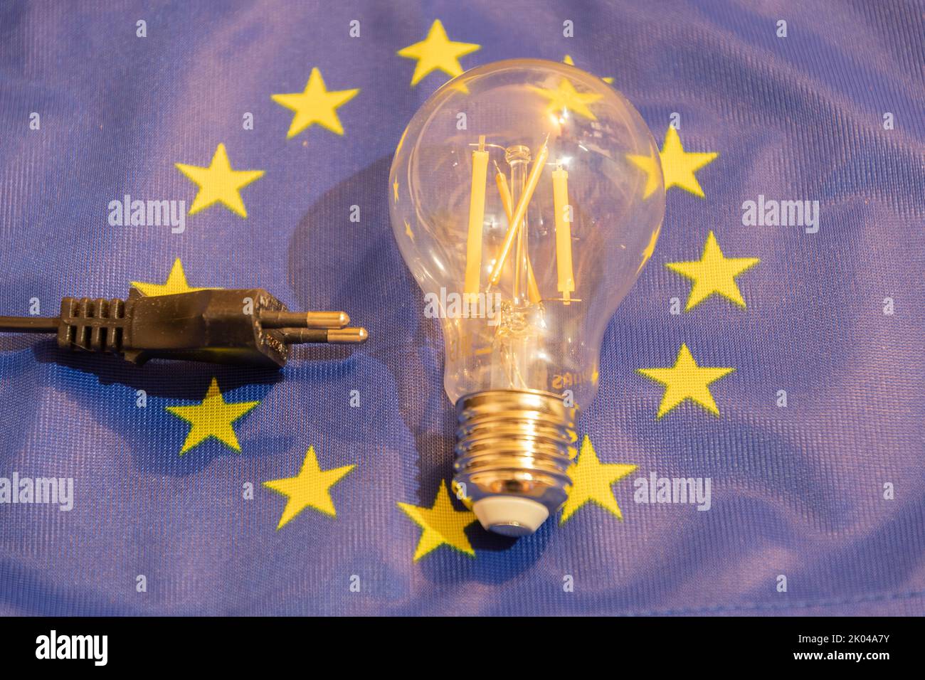 Vaduz, Liechtenstein, September 6, 2022 Light bulb is lying on an european flag to demonstrate the energy crisis Stock Photo